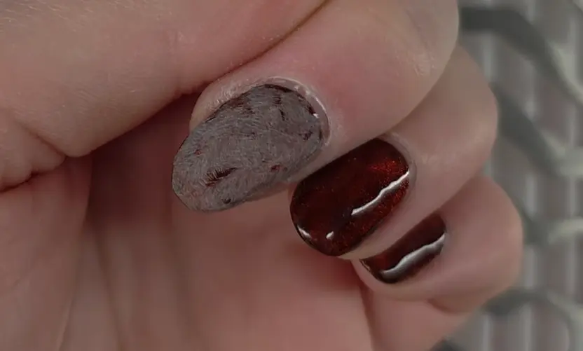 Close-up demonstration of proper filing technique showing 180 grit file removing shine from gel polish top coat