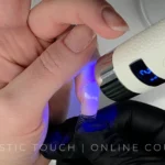 Flash curing technique for no-file BIAB dual forms application showing strategic zone curing method for Cloud Dancer square nails