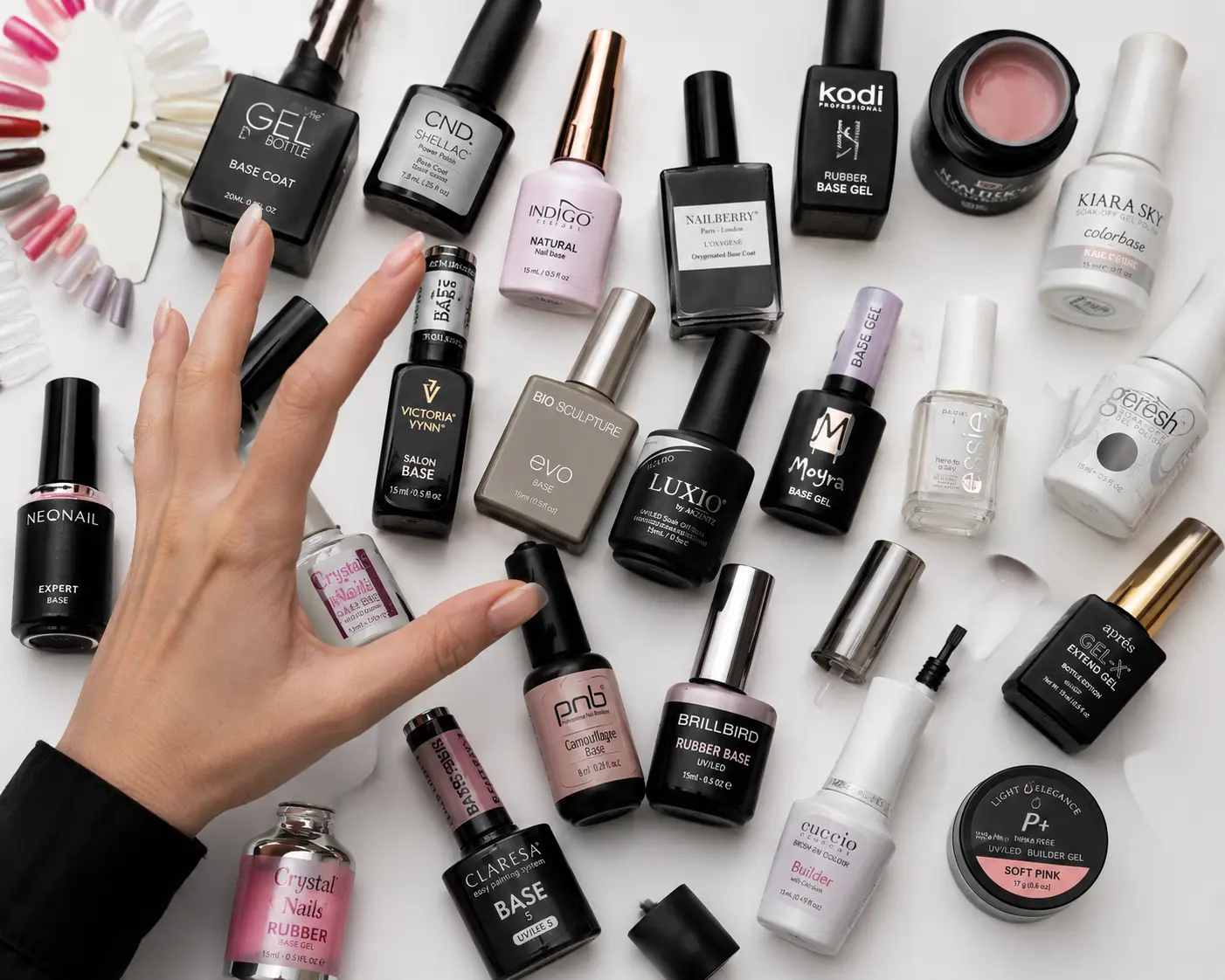 Multiple nail care products scattered showing frustration with product switching for retention problems