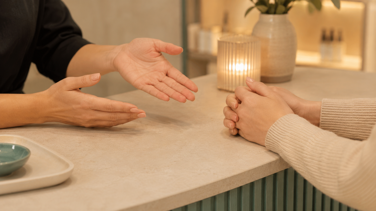 A nail technician calmly explaining the TPO regulation to a client at the salon desk