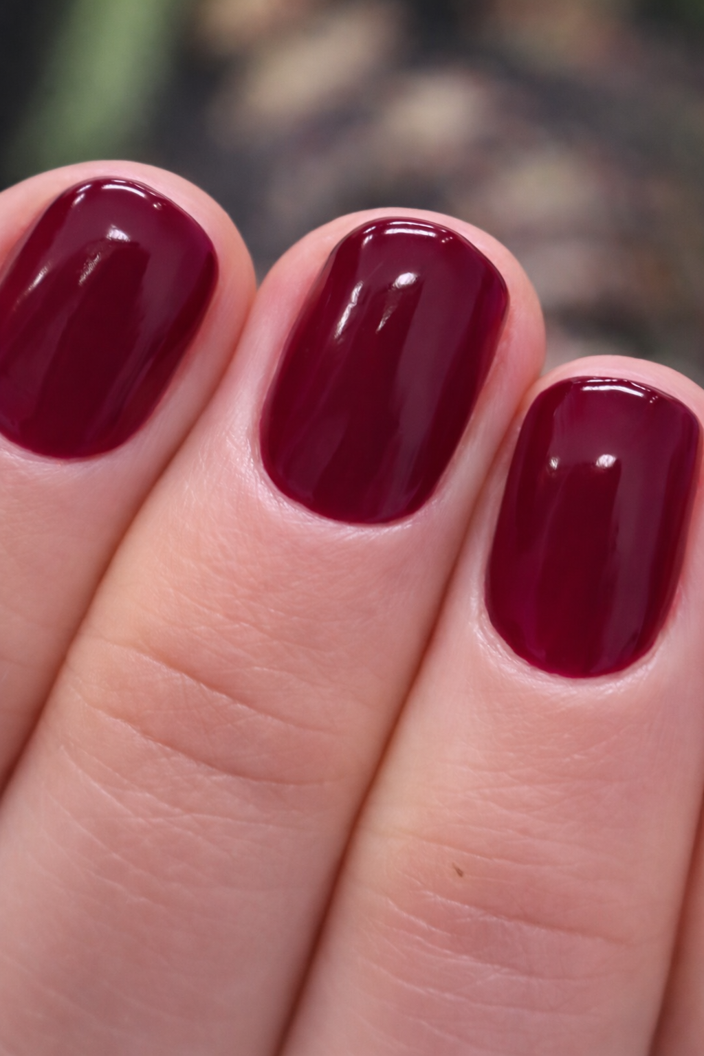 Short glossy burgundy manicure created by Radina Ignatova